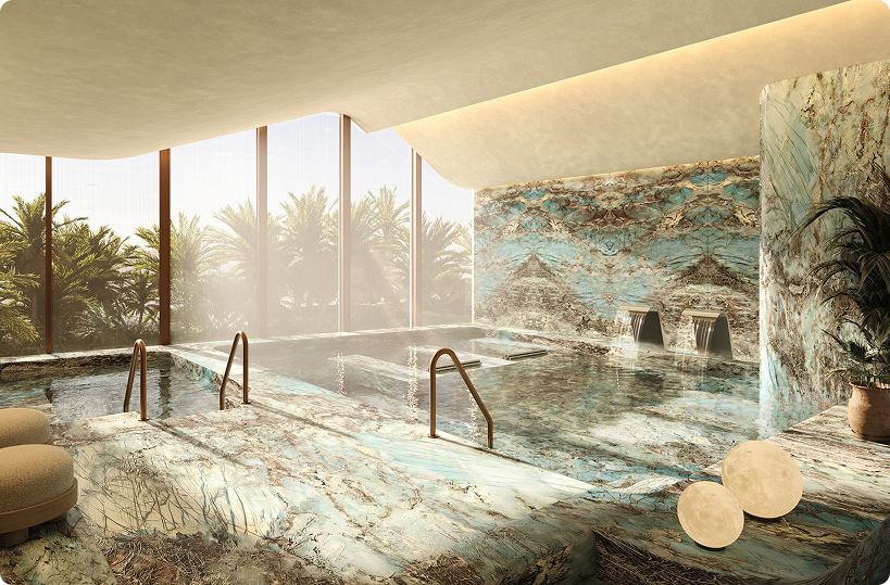 Spa de lujo con diseño en piedra natural, piscina climatizada interior y vistas tropicales, ejemplo de experiencia wellness en Branded Residences.